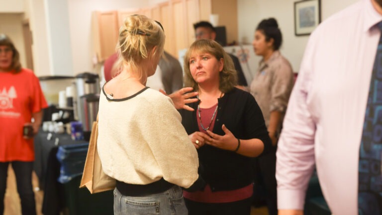 Kristi Farnell (left) and Tamara Davidson (right) discussing concerns in the community at the chamber of commerce open house on July 24