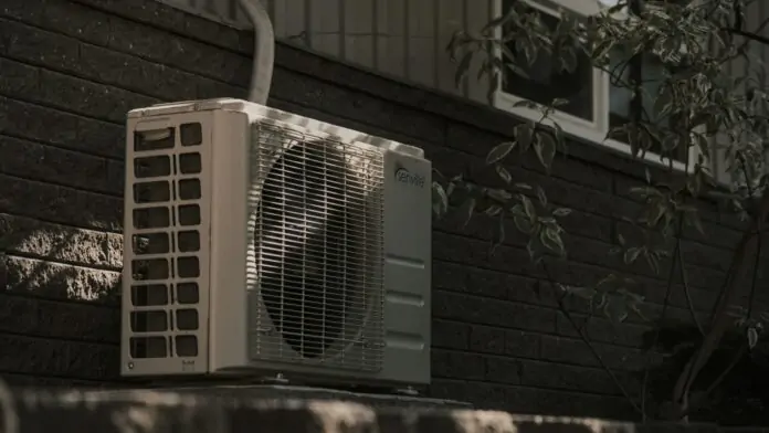 Photo of heat pump air conditioner outside a home.