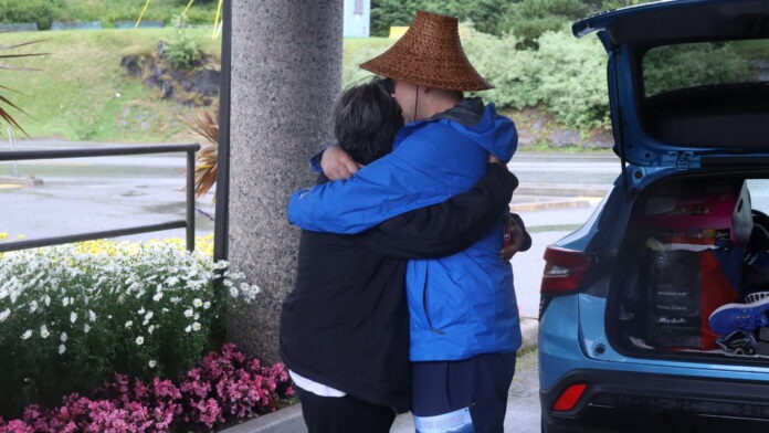 Noah Allison and his mother embracing before he begins his journey to terrace and back