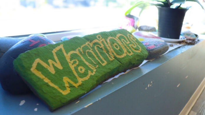 Warrior painted on a rock by a resident of Cranes Crossing supportive housing.