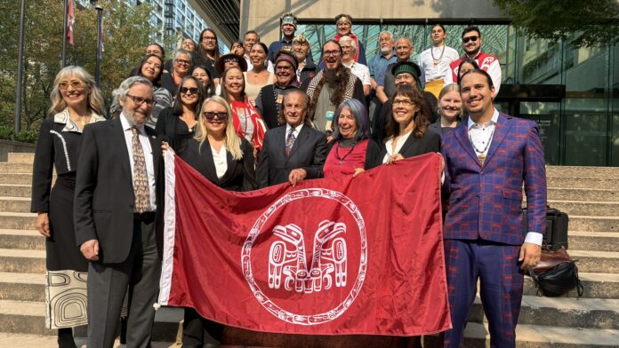 The CHN holding up the Haida flag courtesy of the CHN