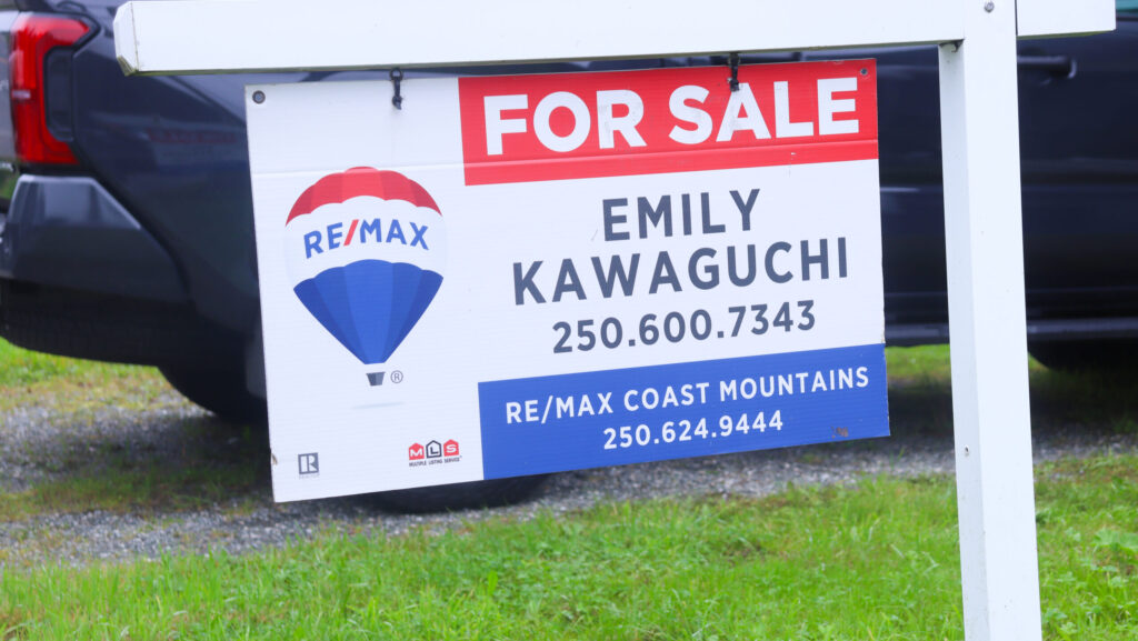 A for sale sign located at a house listing in Prince Rupert