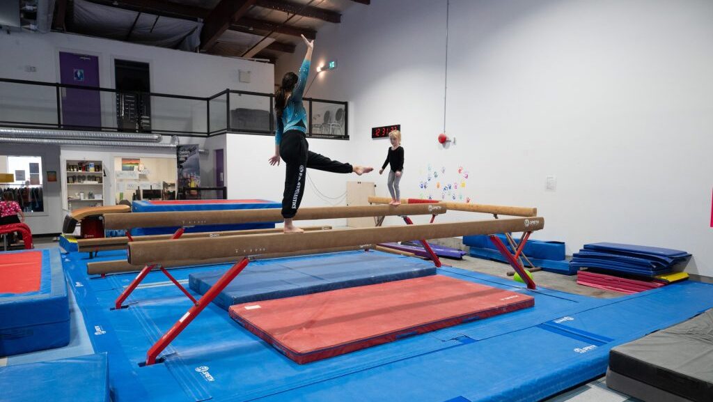 A Prince Rupert gymnast attempting to cross a balance beam. Photo courtesy of the Prince Rupert Port Authority.