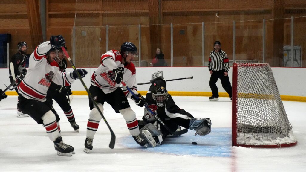 The Hazelton Wolverines sliding the puck past Rampage goaltender Frank Slubowski en route to a 9-3 win. Photo by Logan Flint